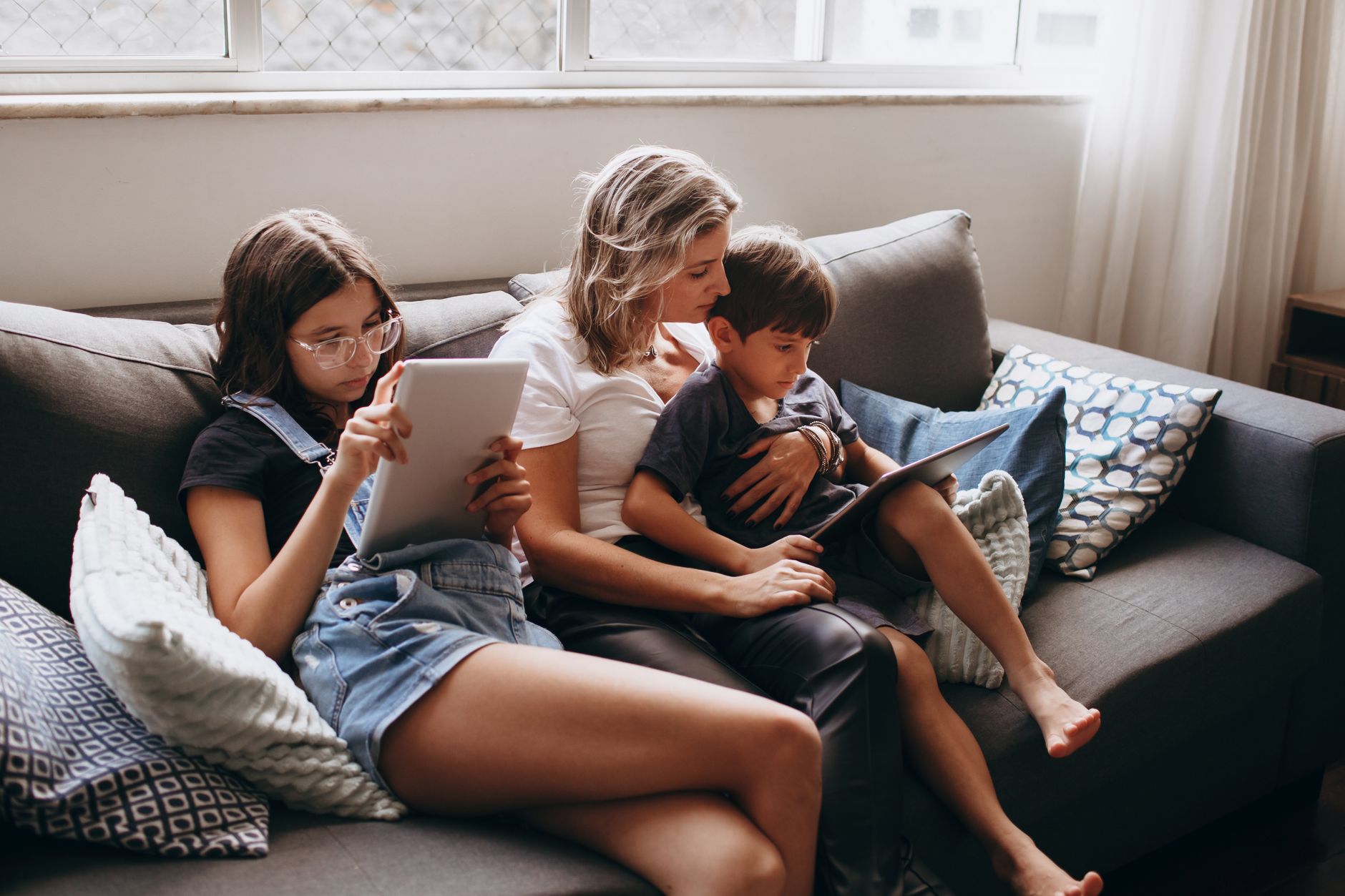 A bright lifestyle photo depicting age specific screen time strategies happy families.